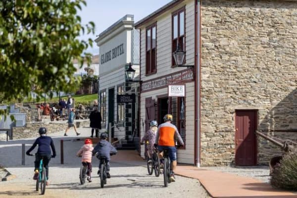 Family cycling on an easy lakeside path in Cromwell